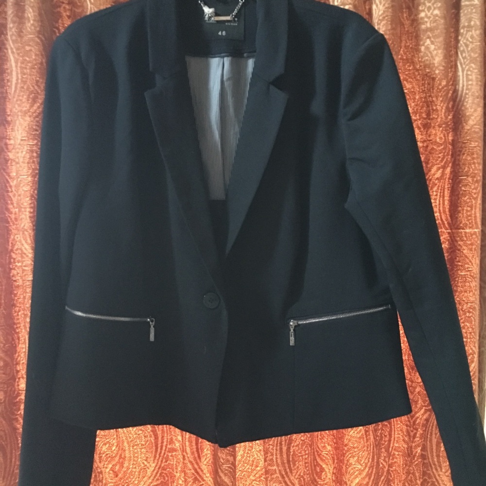 Blue blazer with zipper pockets.